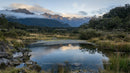 Serene Mountain Landscape with Reflective Pond at Dawn