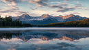 Majestic Mountain Range Reflected in Calm Lake at Sunrise