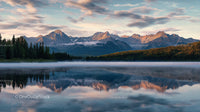 Majestic Mountain Range Reflected in Calm Lake at Sunrise
