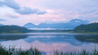 Tranquil Mountain Lake with Misty Morning Reflections
