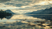 Tranquil Lake and Majestic Mountains at Sunset