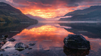 Vibrant Sunset Reflections Over Tranquil Mountain Lake