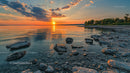 Serene Sunset Over Rocky Shoreline with Vibrant Sky