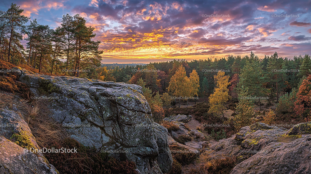 Sunset Over Rocky Forest with Autumn Colors and Dramatic Sky