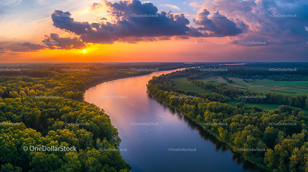 Stunning Aerial View of a River at Sunset with Lush Green Forests