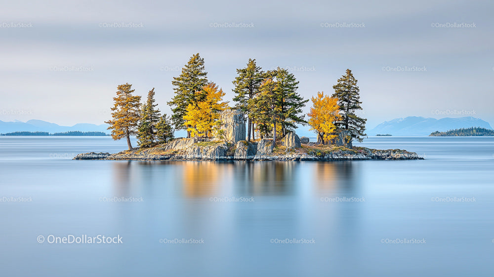 Tranquil Island with Autumn Trees Reflecting on Calm Waters