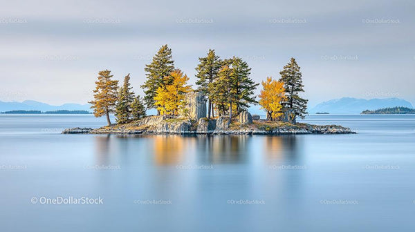 Tranquil Island with Autumn Trees Reflecting on Calm Waters