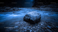 Serene Blue River with Prominent Rock in Mystical Night