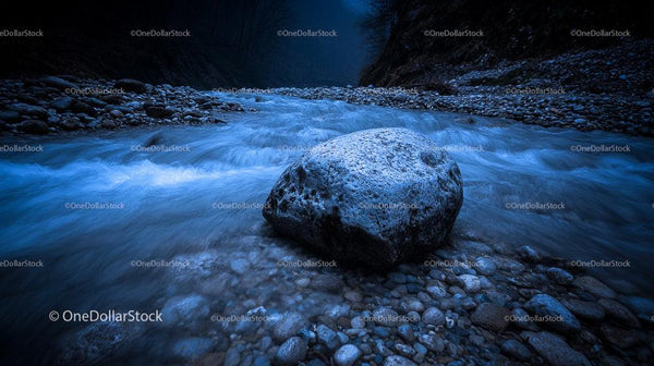 Serene Blue River with Prominent Rock in Mystical Night