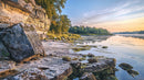 Rocky Shoreline at Dawn with Calm Reflections