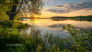 Sunset Over Tranquil Lake with Lush Green Foliage