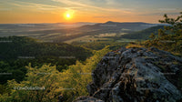 Sunset Over Scenic Mountain Landscape with Lush Greenery