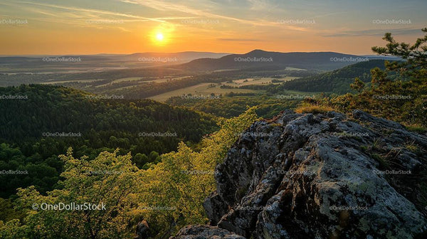 Sunset Over Scenic Mountain Landscape with Lush Greenery