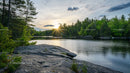 Tranquil Forest Lake at Sunset with Rocky Shore