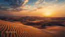 Sunset Over Rolling Sand Dunes with Dramatic Sky