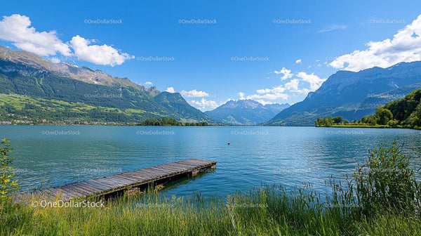 Serene Mountain Lake with Wooden Dock and Clear Sky