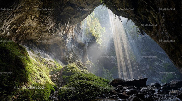 Sunlit Waterfall Flowing Through a Majestic Cave