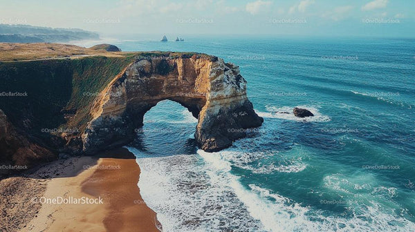 Scenic View of Coastal Arch and Turquoise Ocean Waves