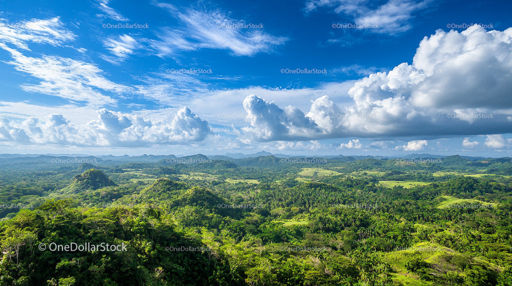 Breathtaking View of Lush Tropical Hills and Blue Sky
