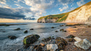 Serene Coastal Sunset with Cliffs and Ocean Waves