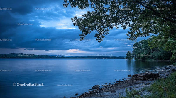 Serene Evening at a Lakeside with Dramatic Cloudscape