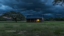 Rustic Barn Under Stormy Evening Sky with Dramatic Clouds