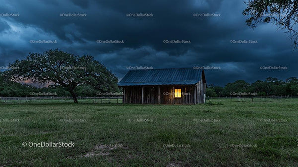 Rustic Barn Under Stormy Evening Sky with Dramatic Clouds