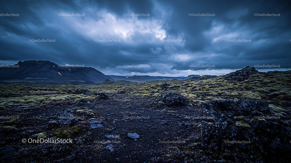 Moody Volcanic Landscape Under Dramatic Overcast Sky