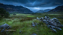 Moody Mountain Landscape with Lush Green Fields and Rocky Terrain