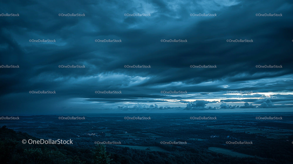Stormy Sky and Dark Clouds Over Vast Landscape