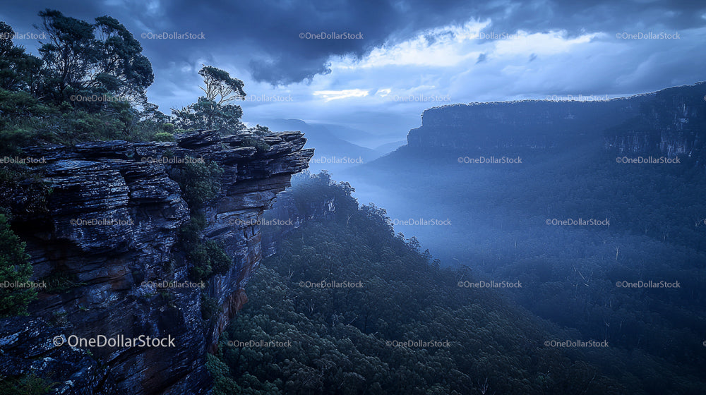 Misty Mountain Cliff with Dramatic Skies at Sunset