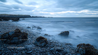 Tranquil Rocky Coastline with Misty Ocean Waves