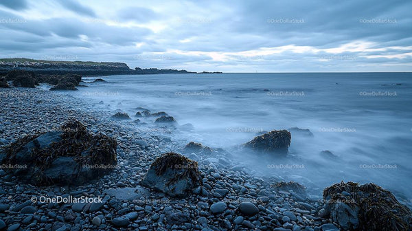 Tranquil Rocky Coastline with Misty Ocean Waves