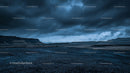 Dramatic Stormy Sky Over Rocky Terrain at Dusk