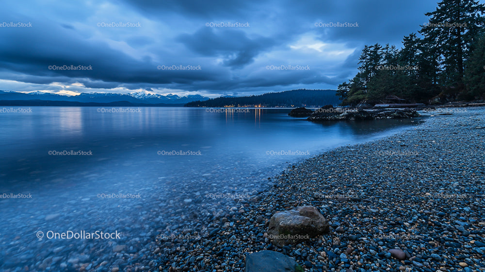 Pebble Beach at Twilight with Mountain and Lake View