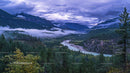Misty Valley with Majestic Mountains and Winding River