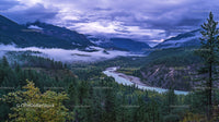 Misty Valley with Majestic Mountains and Winding River