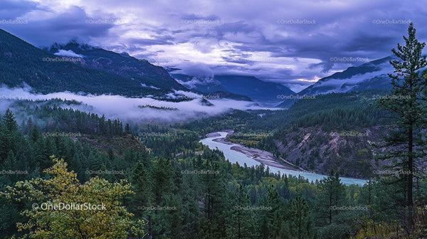 Misty Valley with Majestic Mountains and Winding River