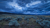 Dramatic Sky Over Sagebrush Field and Mountain Range
