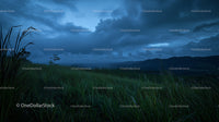 Moody Twilight Over Rolling Hills and Grass Field