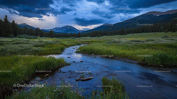 Tranquil Mountain Stream in Lush Valley Under Dramatic Skies