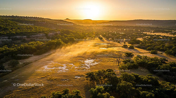 Golden Sunrise Over Foggy Valley and Green Wilderness