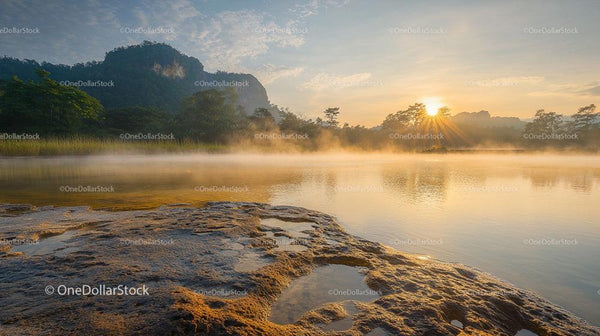 Serene River Sunrise with Mist and Mountain Backdrop