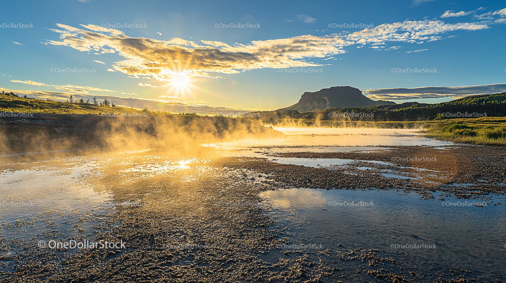 Misty River at Sunrise with Majestic Mountain in Background