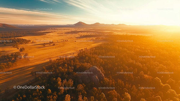 Breathtaking Aerial View of Sunlit Plains at Sunset
