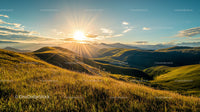 Golden Sunset Over Serene Rolling Hills Landscape