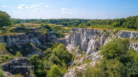 Rocky Cliffs and Lush Greenery Under Bright Blue Sky
