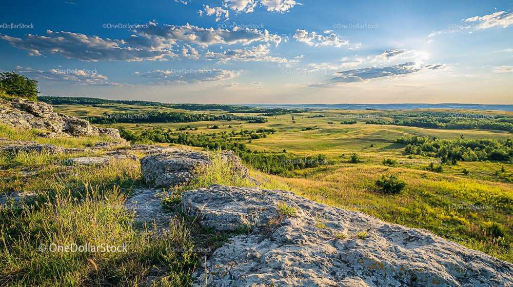 Scenic Rolling Hills and Expansive Fields at Sunset