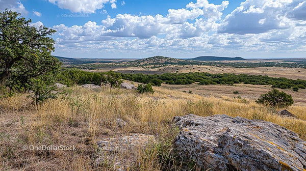 Scenic Landscape with Rolling Hills and Majestic Clouds
