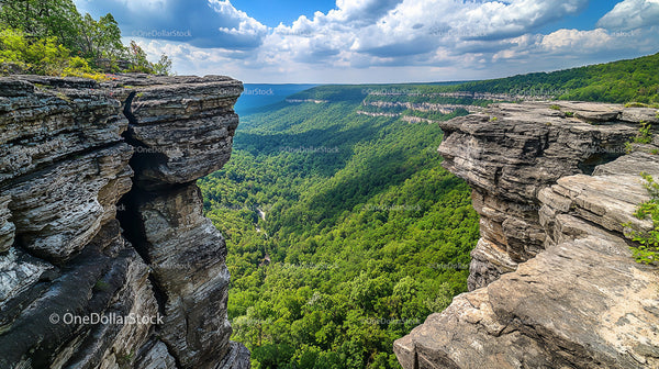Majestic Cliff Overlooking Verdant Valley and Dramatic Sky